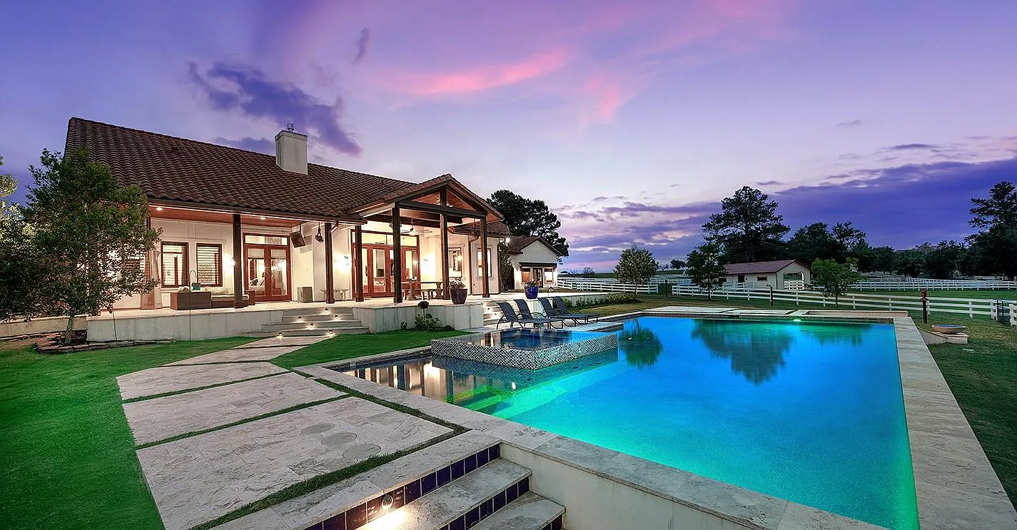 Luxury Texas home with infinity pool at twilight